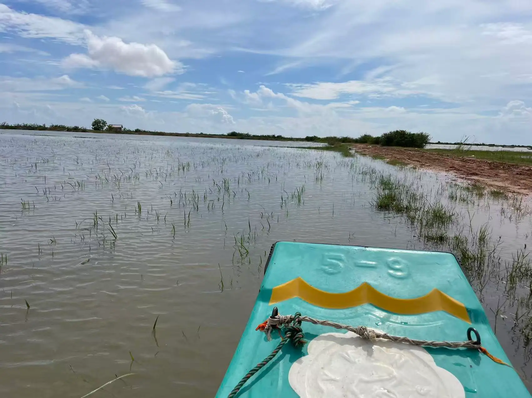 boating-in-the-fields-during-the-cambodian-rainy-season