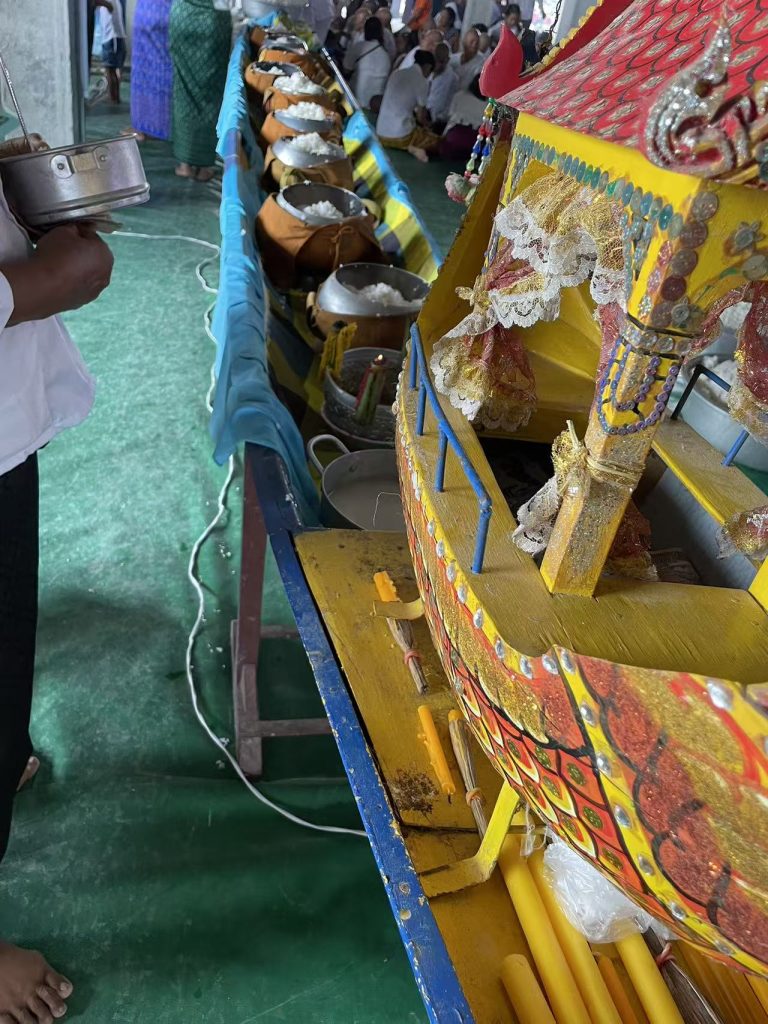 Offerings of rice and food placed in alms bowls and decorated boats as part of the traditional Pchum Ben rituals in a Cambodian temple.