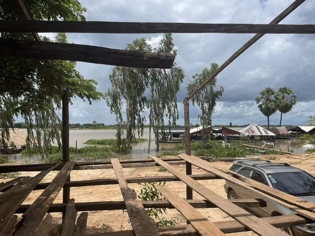 Wooden platform and rural homes by the shore of Makak Water Reservoir in Siem Reap, Cambodia.