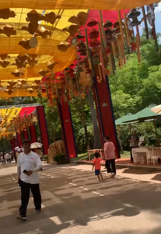 Decorated festival walkway for Cambodian New Year celebration with colorful lanterns and banners.