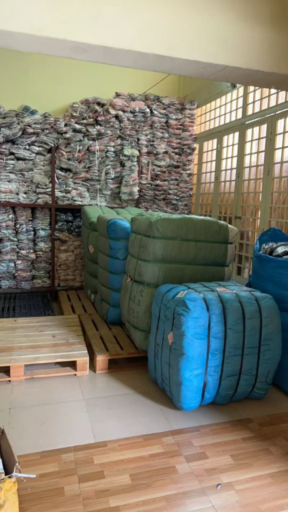 Garment factory storage in Cambodia showing packed clothing ready for distribution
