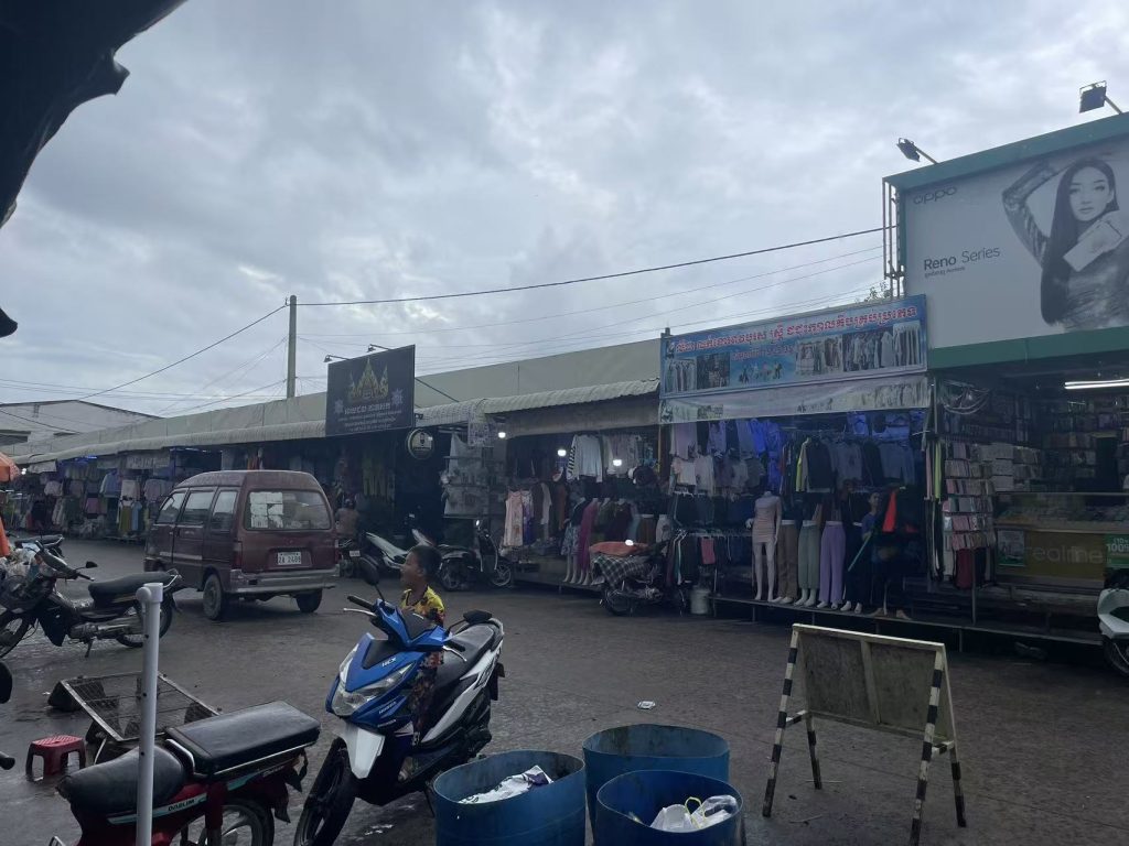 Clothing market in Cambodia with local shops and street vendors selling garments
