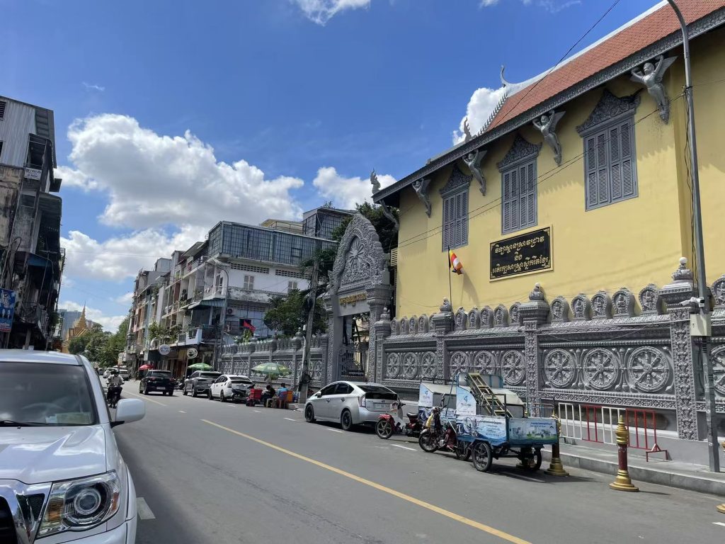 Wat Ounalom Monastery exterior wall and street view in Phnom Penh, Cambodia.