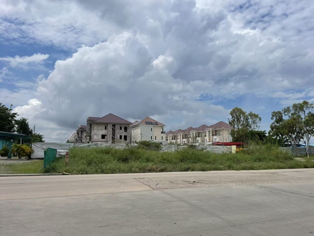 Phnom Penh urban development area under cloudy sky, showing new buildings and open space in Cambodia

